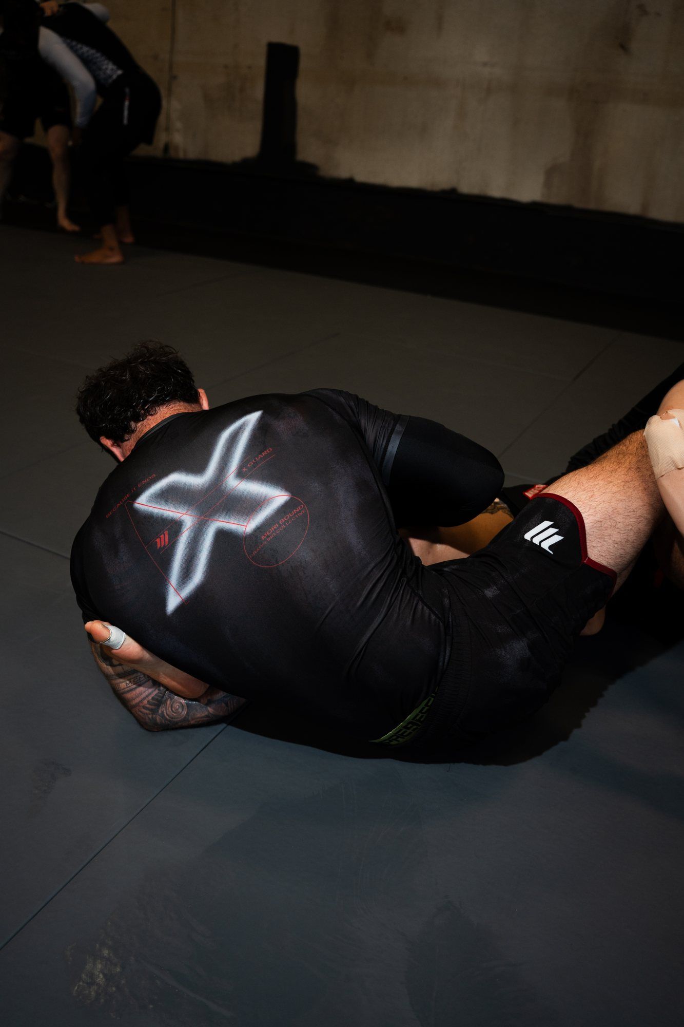 Cam on top of a training partner on the mat