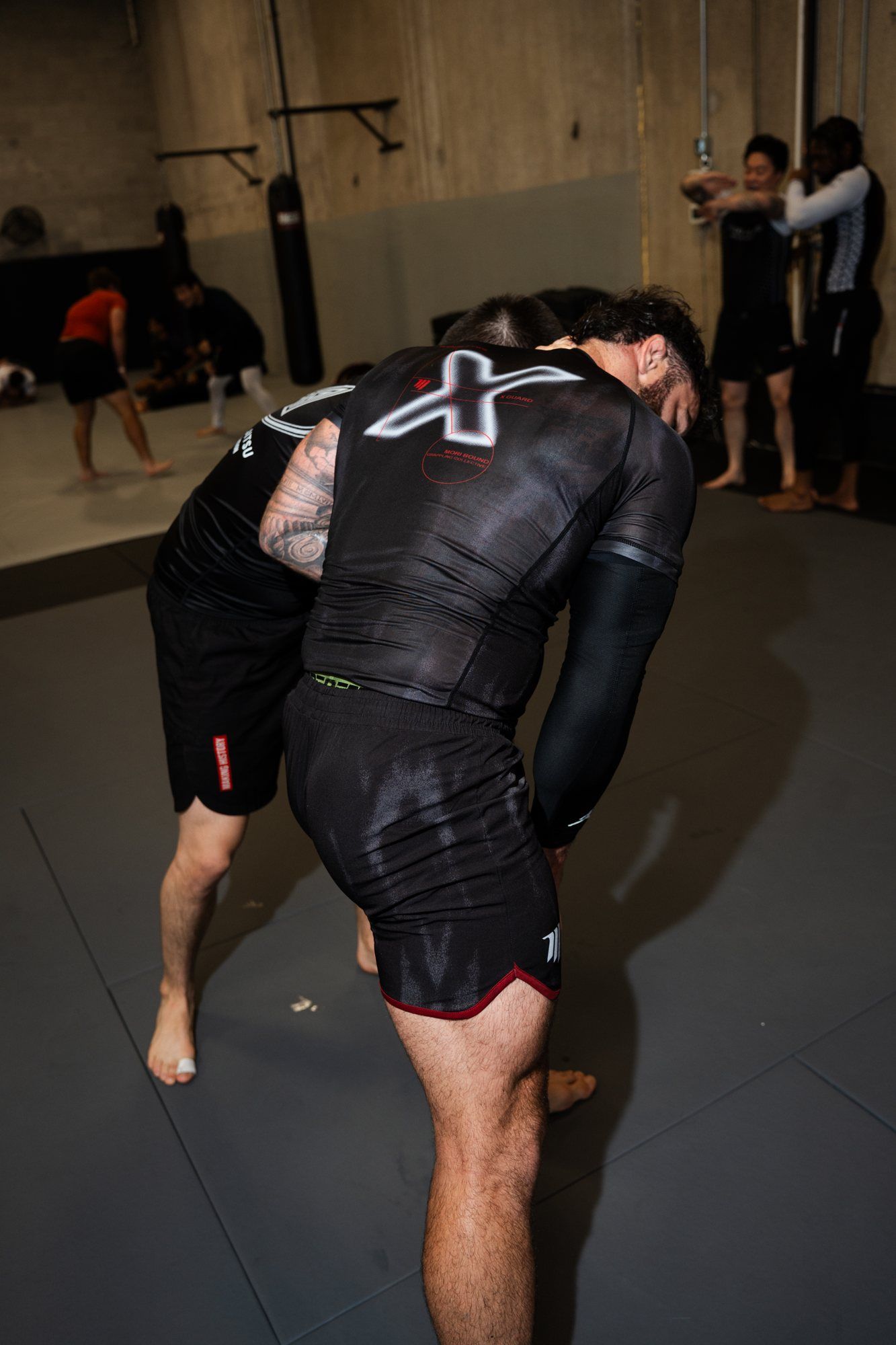 Cam driving into a training partner from a standing tie-up