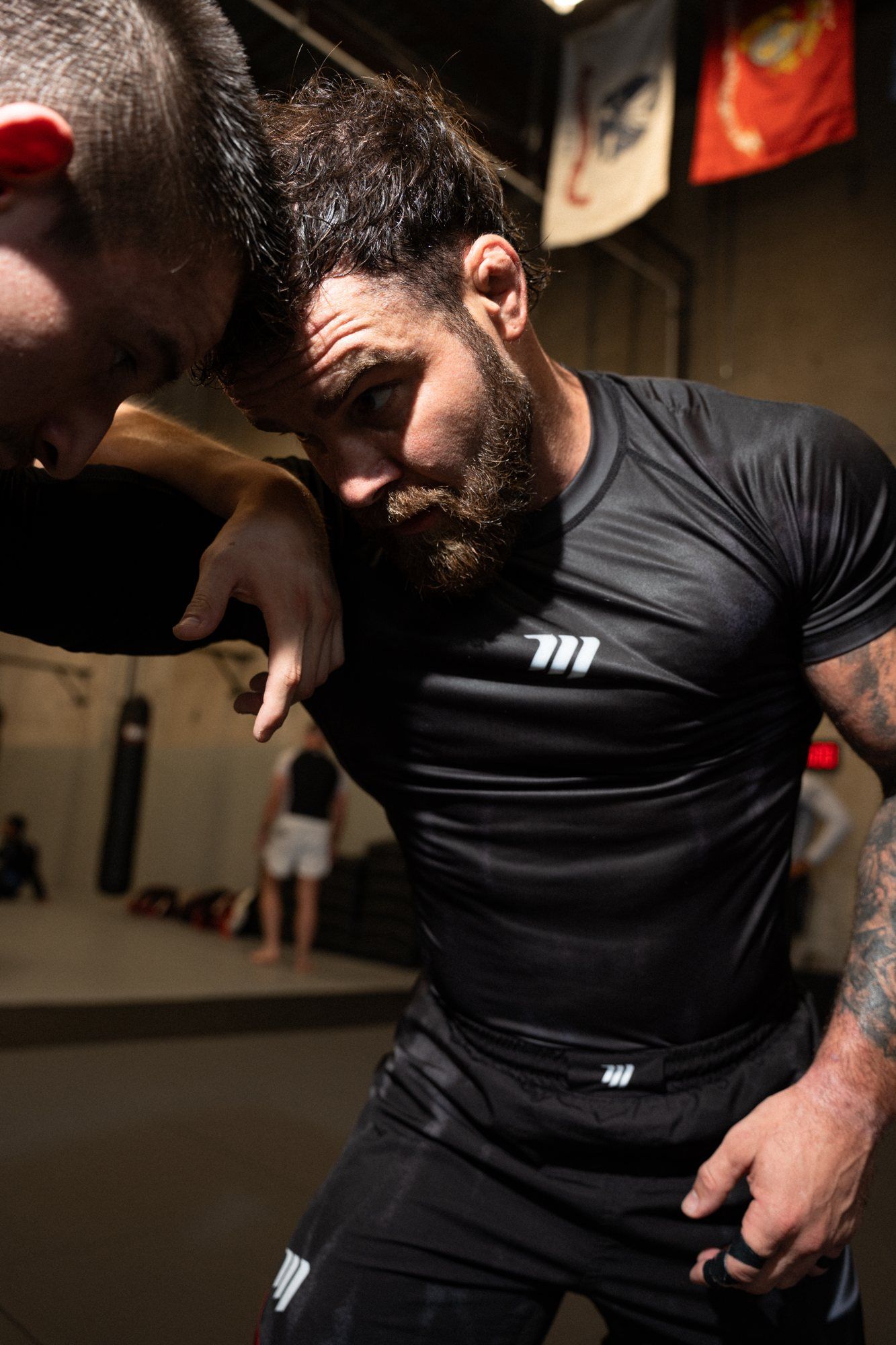 Cam head to head with a training partner, hand-fighting for position
